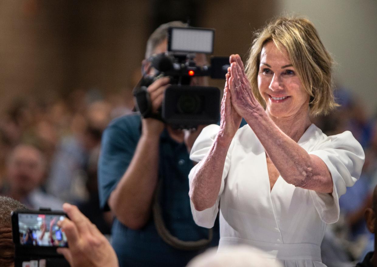 Kelly Craft applauds after combining her bid with Central Bank's for a total bid of $5 million for the country ham at the Kentucky State Fair. The money for the ham will go to charity. Aug. 25, 2022