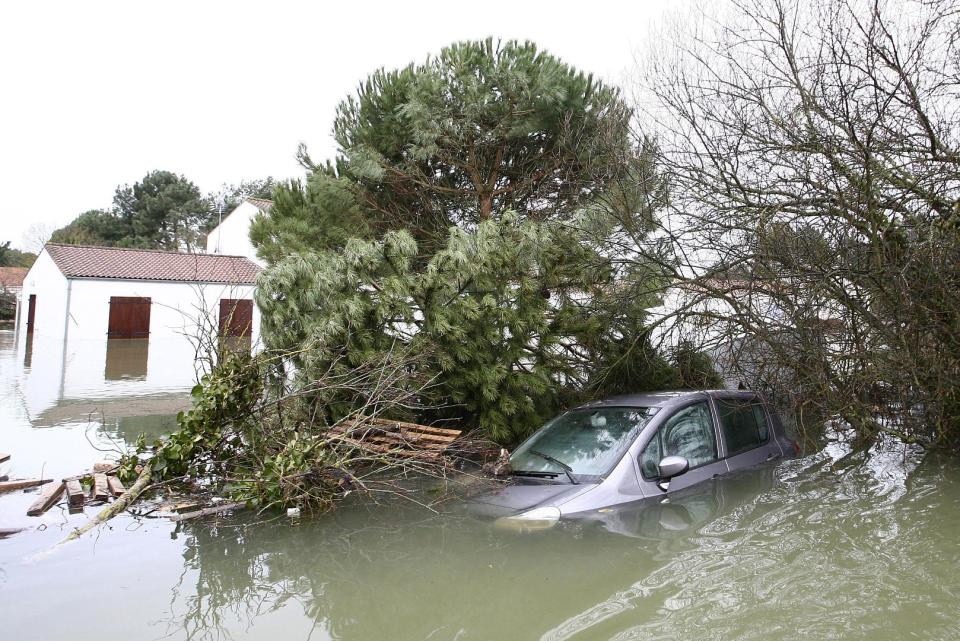 Flooded houses and a car are seen in La Faute sur Mer.