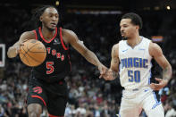 Toronto Raptors guard Immanuel Quickley (5) drives against Orlando Magic guard Cole Anthony (50) during the first half of an NBA basketball game Friday, March 15, 2024, in Toronto. (Frank Gunn/The Canadian Press via AP)