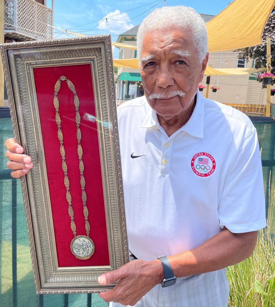 Longtime Akron resident Lester Carney with the silver medal he won in the 200 meters during the 1960 Rome Olympics.