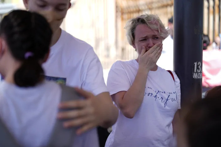 Irina Zolkina, who is seeking asylum in the United States, cries as she recalls her trip from Russia to the Mexican border, standing near the San Ysidro Port of Entry into the United States, in Tijuana, Mexico, Thursday, March 17, 2022. “It’s very hard to understand how they make decisions,” said Zolinka, a 40-year-old Russian woman who camped overnight with her family of seven after arriving in Tijuana on Thursday. (AP Photo/Gregory Bull)