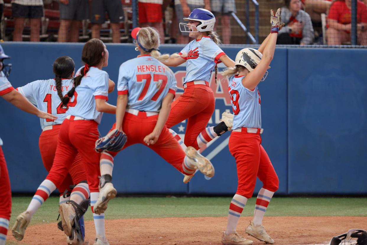 Silo's Avery Beauchamp leaps after crossing for a run to run-rule Dale and win the Class 4A slowpitch softball championship game between Dale and Silo at USA Hall of Fame Stadium in Oklahoma City, Tuesday, April 30, 2024.