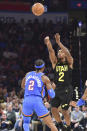 Utah Jazz guard Collin Sexton (2) shoots over Oklahoma City Thunder guard Shai Gilgeous-Alexander during the second half of an NBA basketball game Wednesday, March 20, 2024, in Oklahoma City. (AP Photo/Kyle Phillips)