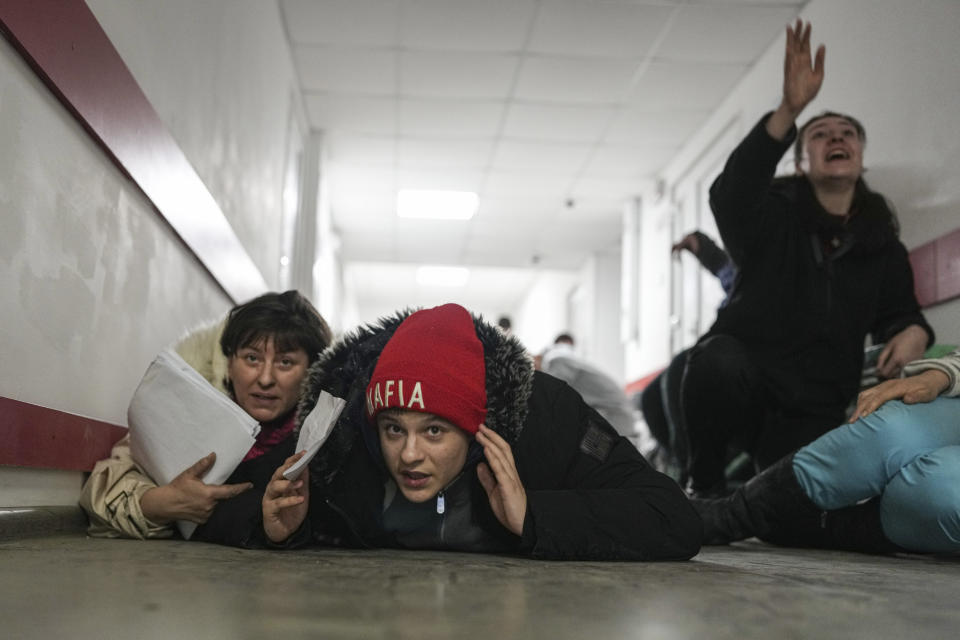 FILE - People lie on the floor of a hospital during shelling by Russian forces in Mariupol, Ukraine, Friday, March 4, 2022. (AP Photo/Evgeniy Maloletka, File)