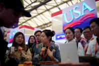 FILE PHOTO: People visit U.S. food booths at SIAL food innovation exhibition, in Shanghai, China, May 14, 2019. REUTERS/Aly Song