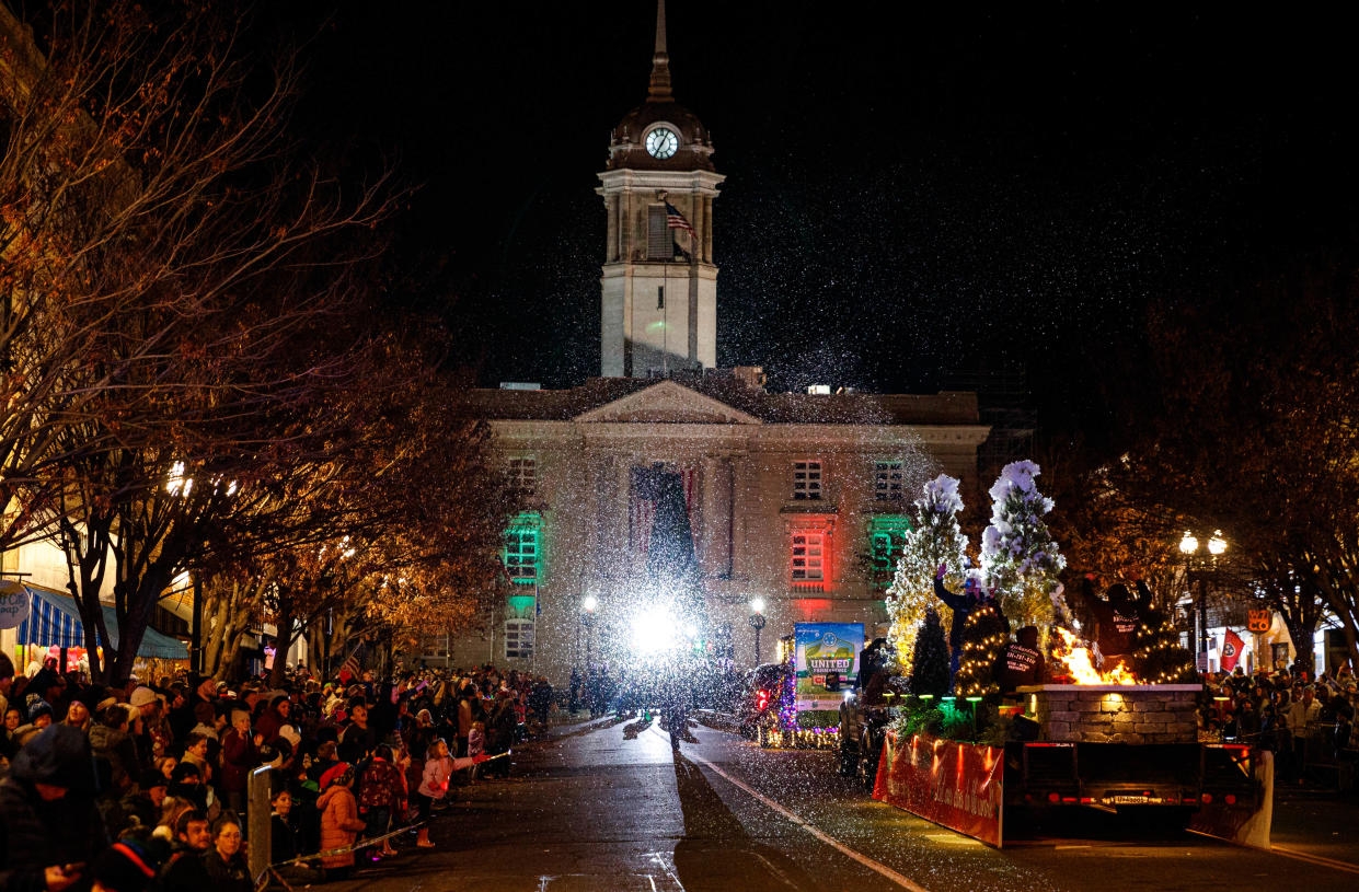 The Richardson Lawn and Landscape float sports an artificial snow blower and a fire pit during the annual Christmas parade and tree lighting in downtown Columbia, Tenn. on Dec. 3, 2022. 