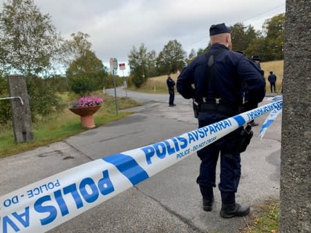 Police are seen outside Villa Elfik Strand at Lidingo