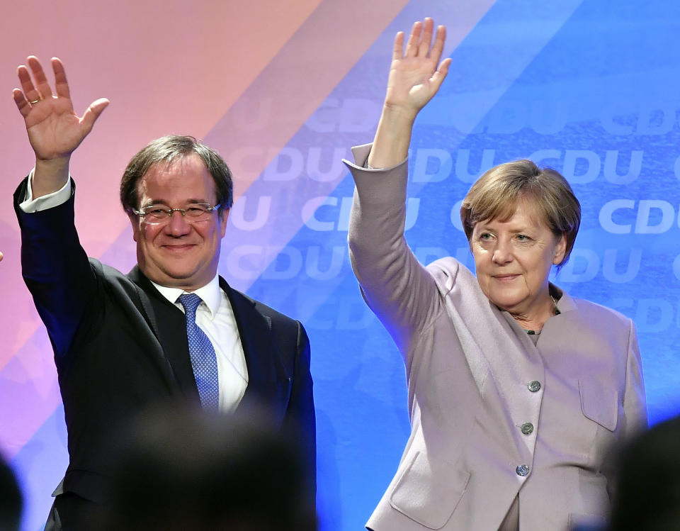 FILE - In this Thursday, April 27, 2017 file photo Christian Democrats candidate Armin Laschet and German chancellor Angela Merkel wave to supporters during a state election campaign in Oelde, Germany. Laschet, the 60-year-old governor of Germany's most populous state, is the front-runner to succeed Angela Merkel as chancellor in the country's Sept. 26 election. (AP Photo/Martin Meissner, File)