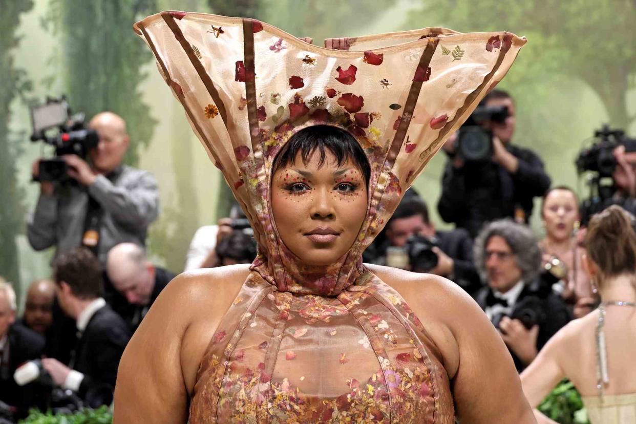 <p>Jamie McCarthy/Getty</p> Lizzo responds to critics of her 2024 Met Gala look