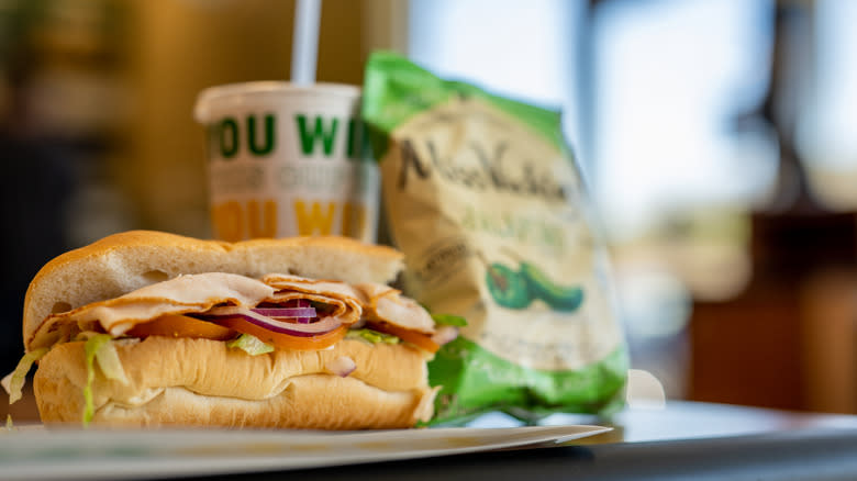 Subway sandwich and meal on restaurant table