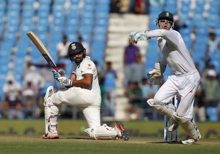 India's Rohit Sharma (L) plays a shot past South Africa's wicketkeeper Dane Vilas during the second day of their third test cricket match in Nagpur, India, November 26, 2015. REUTERS/Amit Dave