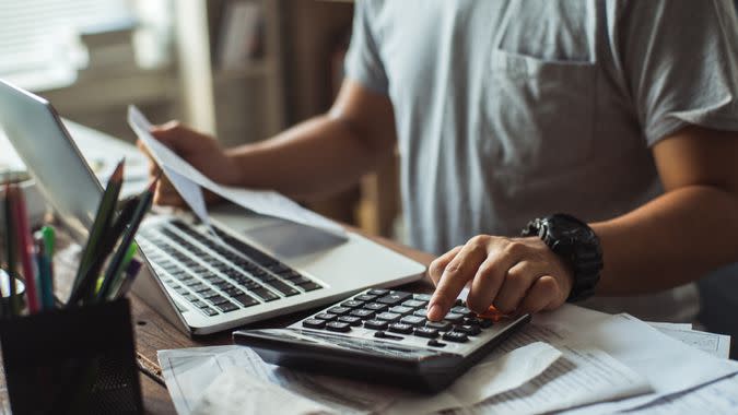 Man is calculating the cost of the bill.