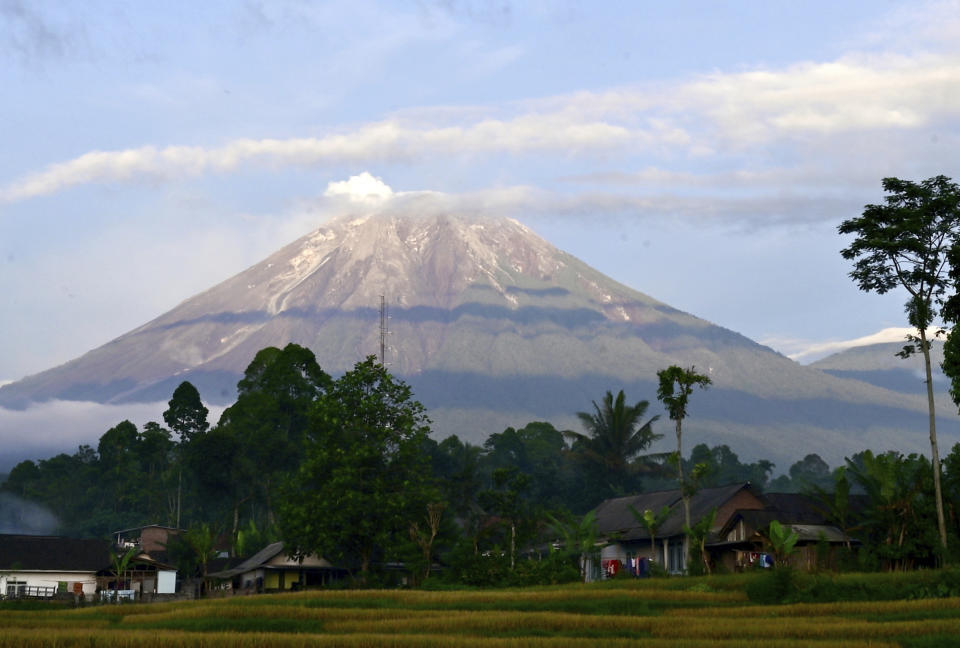 Mount Semeru is seen in Lumajang district, East Java province, Indonesia, Saturday, Dec. 18, 2021. Indonesian authorities raised the alert level for the highest volcano on Java island, saying Mount Semeru could blow up again after a sudden eruption earlier this month that killed a number of people and left thousands homeless in villages that were buried in layers of mud. (AP Photo/Hendra Permana)