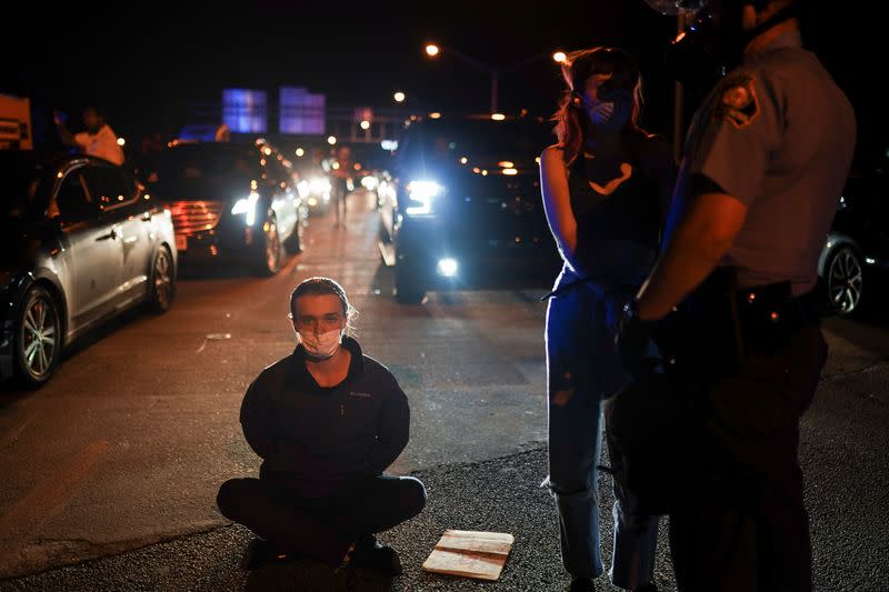 Police detain protesters for blocking traffic during a rally against racial inequality and the police shooting death of Rayshard Brooks, in Atlanta