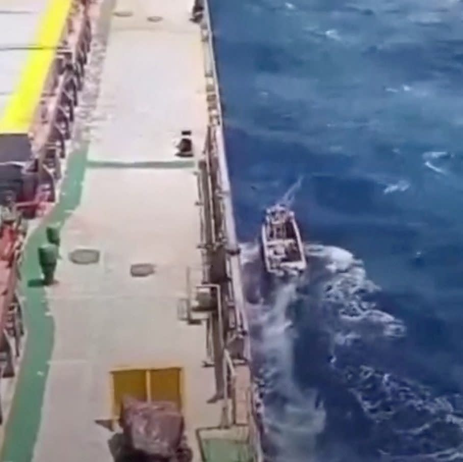 A boat sails next to the MV Abdullah in this screengrab obtained from a social media video released on March 12