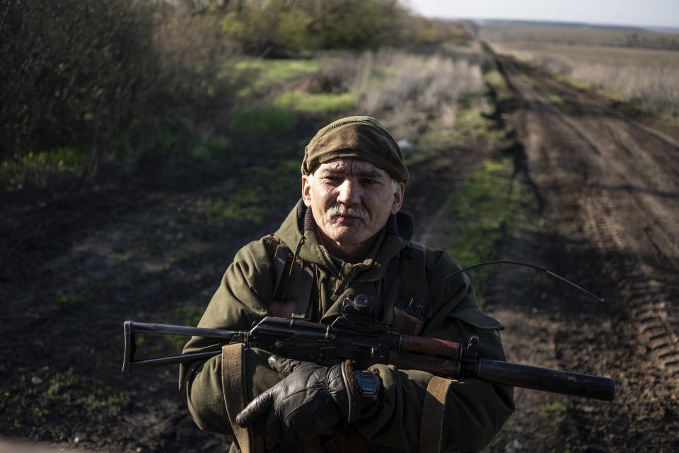 FILE In this file photo taken on Sunday, April 21, 2019, a Ukrainian serviceman guards a position near the front line as the conflict continues in Donetsk region, eastern Ukraine. Ukraine's president sits down Monday, Dec. 9, 2019 for peace talks in Paris with Russian President Vladimir Putin in their first face-to-face meeting, and the stakes could not be higher. More than five years of fighting in eastern Ukraine between government troops and Moscow-backed separatists has killed more than 14,000 people, and a cease-fire has remained elusive. (AP Photo/Evgeniy Maloletka, File)