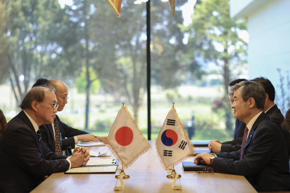 In this photo provided by South Korea Presidential Office, Takeo Akiba, Japan's National Security Adviser, left, meets with Cho Tae-yong, South Korean National Security Adviser, right, in Seoul, South Korea, Wednesday, May 3, 2023. (South Korea Presidential Office via AP)