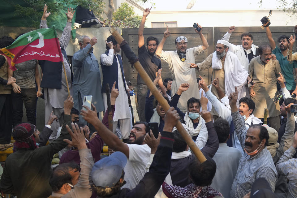 Supporters of former Prime Minister Imran Khan chant anti government slogans as they gather outside Khan's residence, in Lahore, Pakistan, Wednesday, March 15, 2023. Pakistani police have paused efforts to arrest former Prime Minister Imran Khan on graft charges after clashes continued for a second day outside his home in the eastern city of Lahore. (AP Photo/K.M. Chaudary)