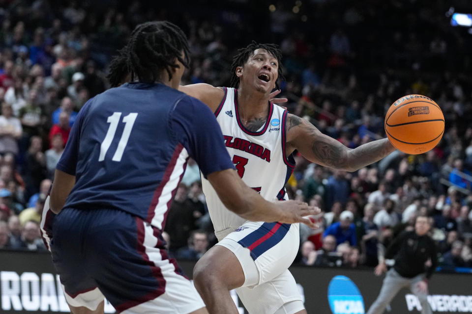 Florida Atlantic forward Giancarlo Rosado (3)] looses the ball in front of Fairleigh Dickinson forward Sean Moore (11) in the second half of a second-round college basketball game in the men's NCAA Tournament in Columbus, Ohio, Sunday, March 19, 2023. Florida Atlantic defeated Fairleigh Dickinson 78-70. (AP Photo/Michael Conroy)