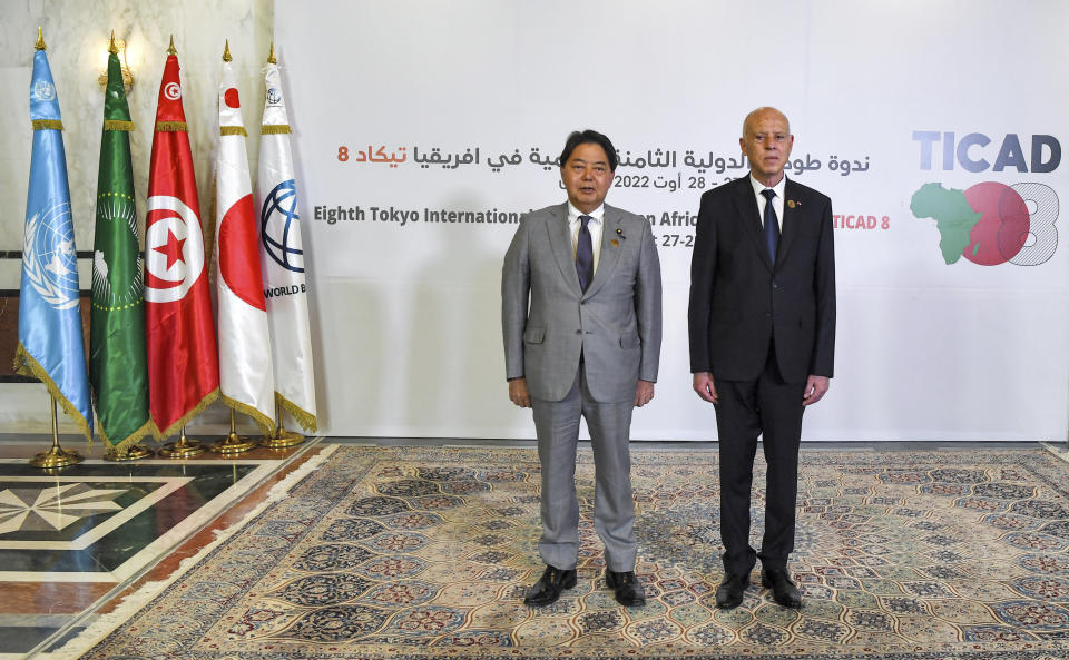 Tunisia's President Kais Saied, right, and Japan's Foreign Minister Yoshimasa Hayashi pose for a photo during the eighth Tokyo International Conference on African Development (TICAD) in Tunisia's capital Tunis on Saturday, Aug. 27, 2022. African heads of state, representatives of international organizations and private business leaders are in Tunisia this weekend for the eighth iteration of the Tokyo International Conference on African Development, a triennial event launched by Japan to promote growth and security in Africa. (Fethi Belaid/Pool Photo via AP)