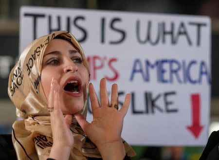 A demonstrator against the immigration rules implemented by U.S. President Donald Trump's administration, protests at Los Angeles international airport in Los Angeles, California, U.S., February 4, 2017. REUTERS/Ringo Chiu