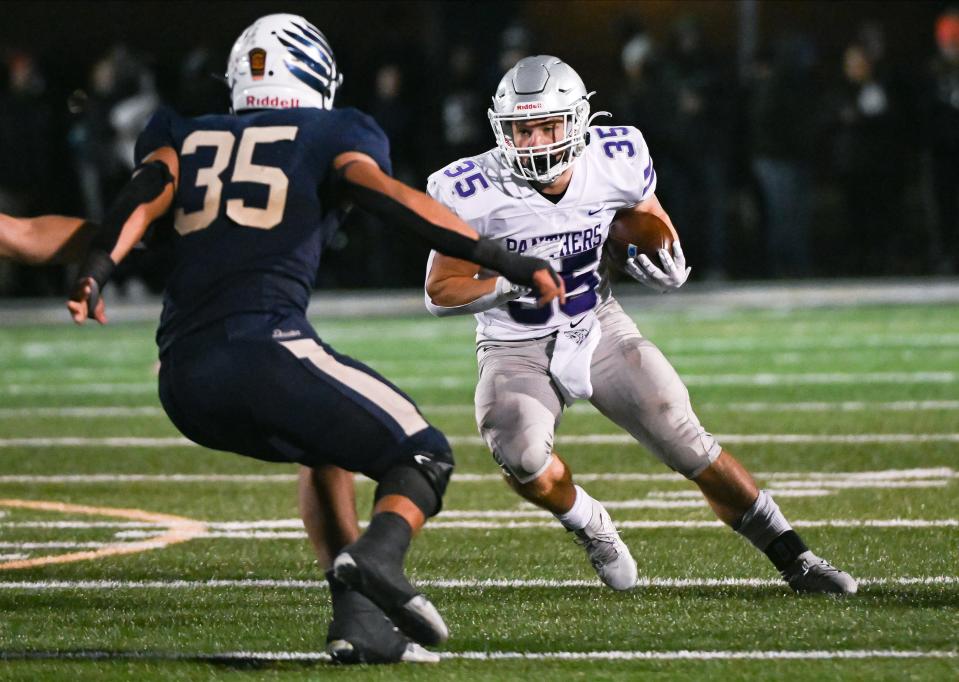 Bloomington South’s Gavin Adams (35) runs the ball against Decatur Central’s Halbert Aguirre (35) during the IHSAA 5A semistate football game at Decatur Central on Friday, Nov. 17, 2023.