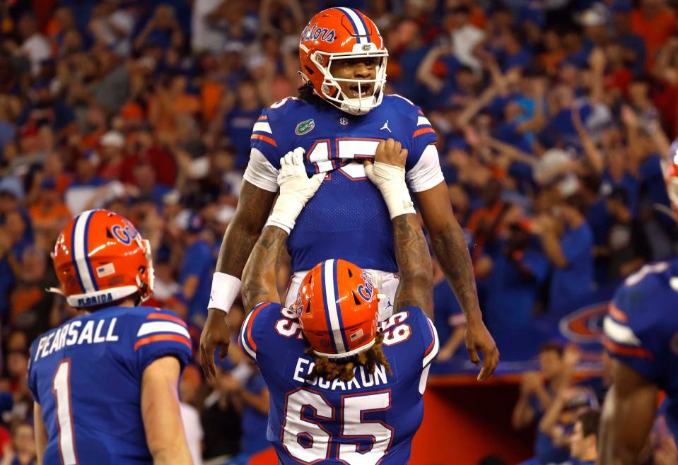 Florida Gators quarterback Anthony Richardson (15) is congratulated  by  offensive lineman Kingsley Eguakun (65) after he scored a touchdown against the Utah Utes during the second quarter at Steve Spurrier-Florida Field.