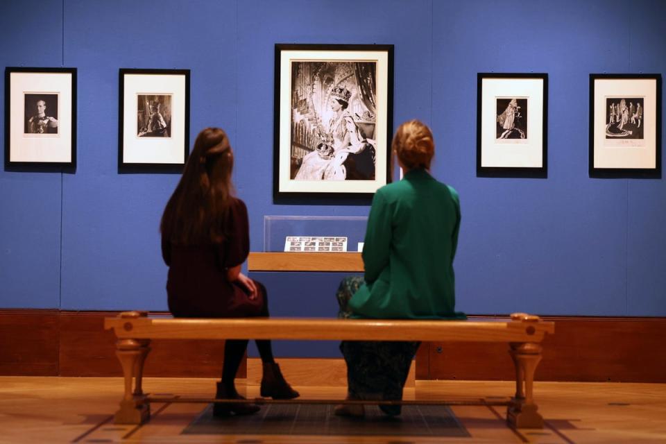 Gallery workers view photographs of Queen Elizabeth II by Cecil Beaton (EPA)