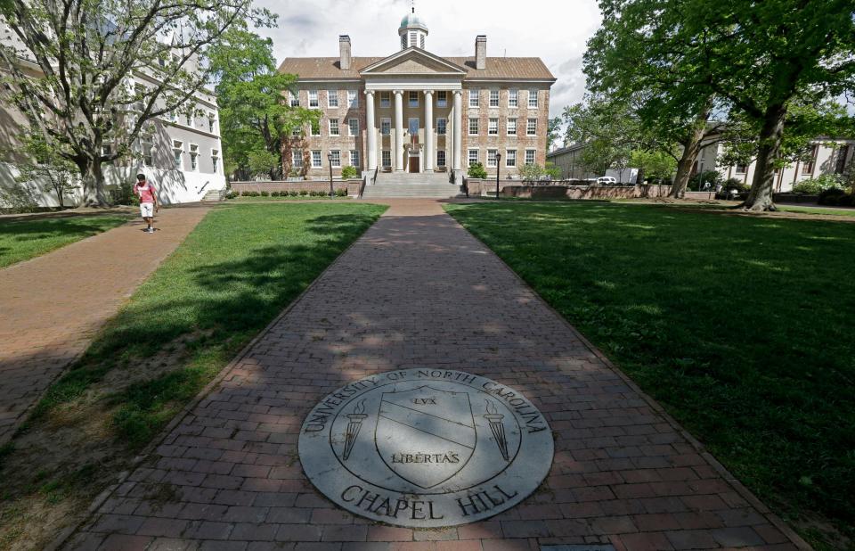 In this photo taken Monday, April 20, 2015, a sidewalk leads to the South Building on campus at The University of North Carolina in Chapel Hill, N.C.