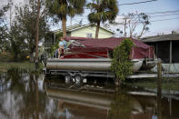 <p>A person sits atop a pontoon in Fort Myers, Florida, on Sept. 29.</p>