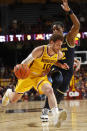 Minnesota forward Jamison Battle (10) works around Michigan forward Tarris Reed Jr. (32) during the first half of an NCAA college basketball game Thursday, Dec. 8, 2022, in Minneapolis. (AP Photo/Bruce Kluckhohn)