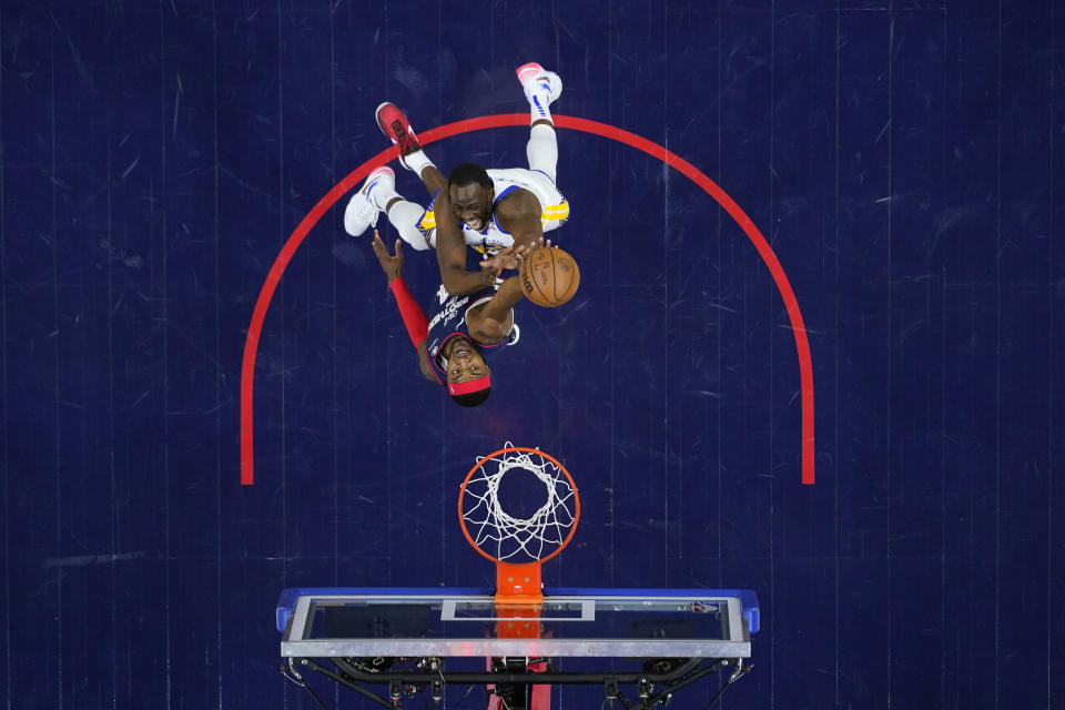 Golden State Warriors' Draymond Green, top, goes up for a shot against Philadelphia 76ers' Paul Reed during the first half of an NBA basketball game, Wednesday, Feb. 7, 2024, in Philadelphia. (AP Photo/Matt Slocum)