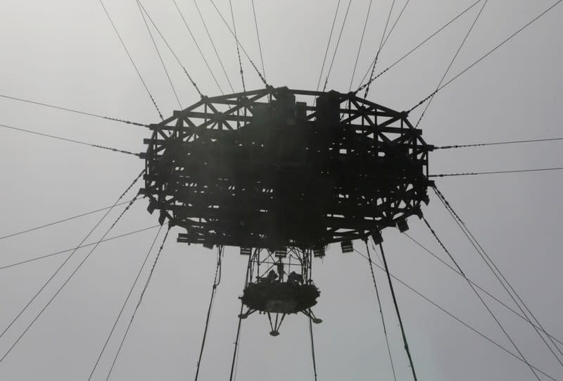 Lander is hanged for a hovering-and-obstacle avoidance test for China's Mars mission at a test facility in Huailai