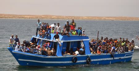 Illegal migrants are seen on a boat after being rescued by the Tunisian navy off the coast near Ben Guerdane, Tunisia, June 10, 2015. REUTERS/Stringer