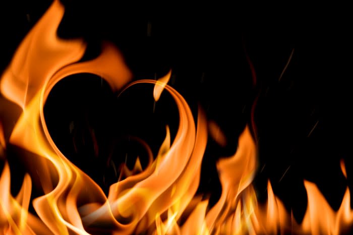 The shape of a heart formed by flames.