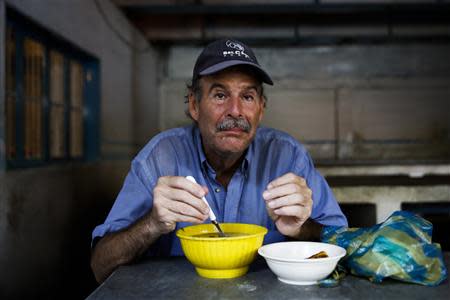 Vladimir Garcia, 56, poses for a picture at the Mother Teresa of Calcutta eating center in Caracas March 19, 2014. REUTERS/Carlos Garcia Rawlins