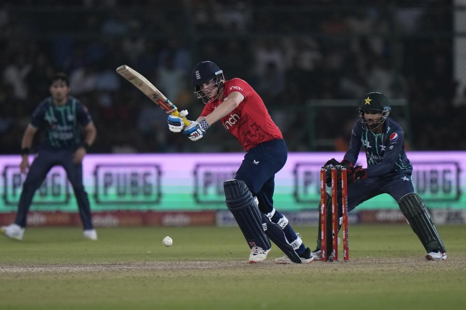 England's Harry Brook, center, plays a shot during the fourth twenty20 cricket match between Pakistan and England, in Karachi, Pakistan, Sunday, Sept. 25, 2022. (AP Photo/Anjum Naveed)