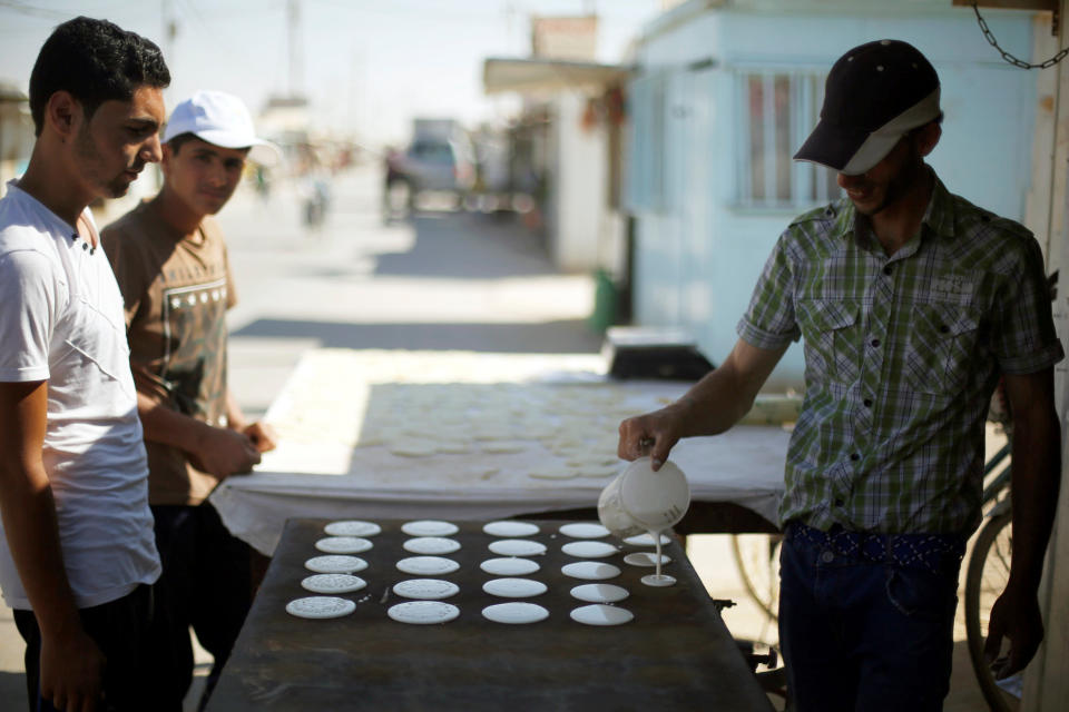 A Syrian refugee man makes traditional sweets during the Muslim fasting month of Ramadan at the Al-Zaatari camp June 1.