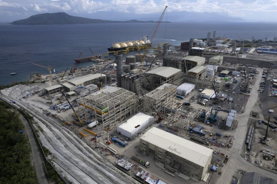 The Ilijan liquified natural gas plant is visible with Verde Island, in the distance, along the coast of Ilijan, Batangas province, Philippines on Friday, Aug. 11, 2023. The Philippines is seeing one of the world's biggest buildouts of natural gas infrastructure. (AP Photo/Aaron Favila)