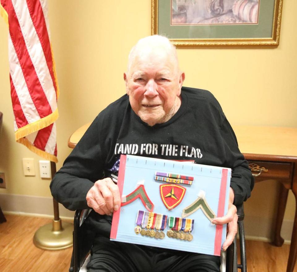 WWII veteran and proud U.S. Marine Paul Frederick held the 14 medals he earned in combat, including the Purple Heart, on June 21, 2024, at the Thomson-Hood Veterans Center campus in Wilmore, Ky.