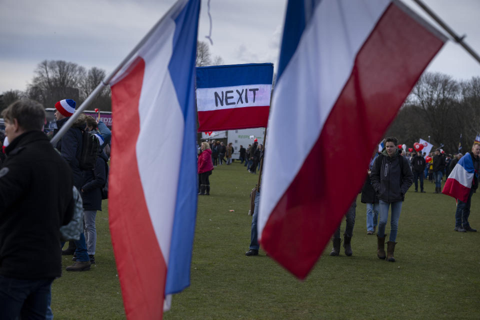 Netherlands flags fly upside-down in protest with one reading NEXIT, referring to a Netherlands Exit of the EU, as thousands of demonstrators joined an anti-government protest by farmers' organizations in The Hague, Netherlands, Saturday, March 11, 2023. The protest comes days before Dutch provincial elections on March 15, in which a party representing farmers' interests is expected to perform well. (AP Photo/Peter Dejong)