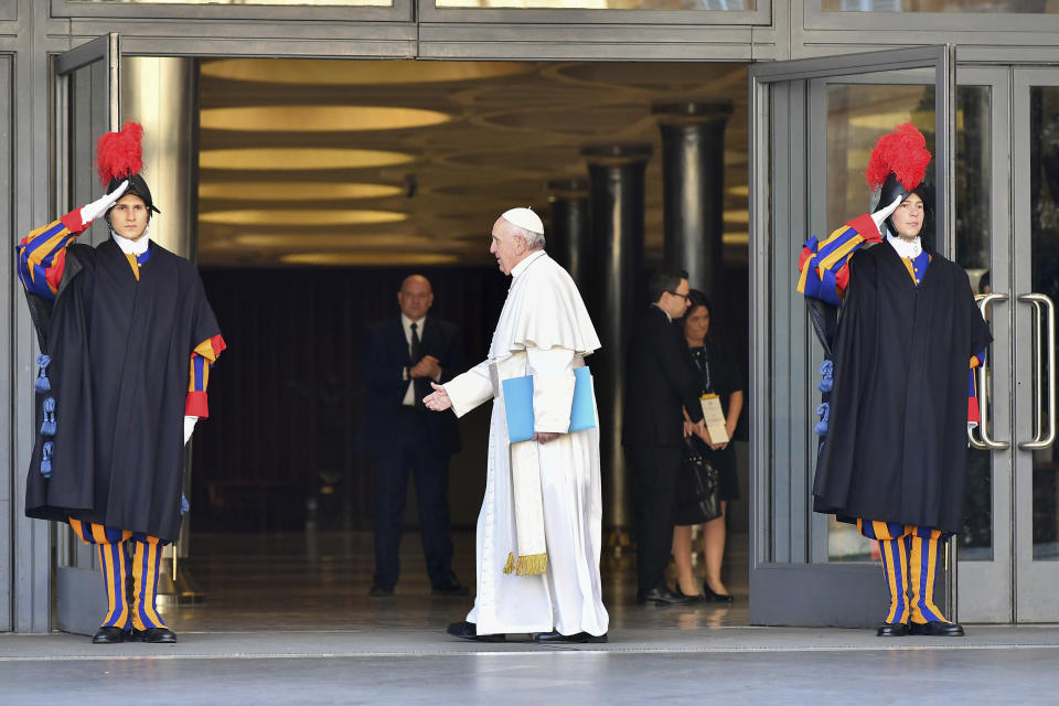 Pope Francis goes to greet a Vatican Swiss guard as he arrives for the opening of a sex abuse prevention summit, at the Vatican, Thursday, Feb. 21, 2019. The gathering of church leaders from around the globe is taking place amid intense scrutiny of the Catholic Church's record after new allegations of abuse and cover-up last year sparked a credibility crisis for the hierarchy. (Vincenzo Pinto/Pool Photo via AP)
