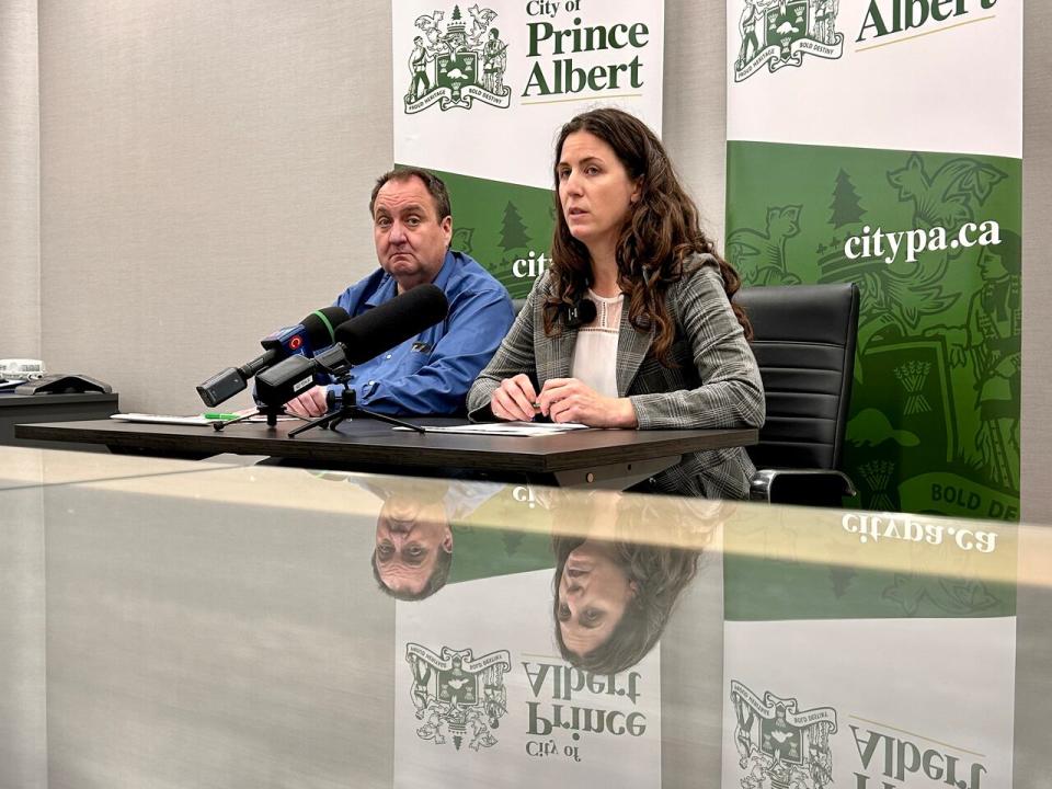 Kiley Bear, director of corporate services for the City of Prince Albert, right, speaks during a news conference about the strike. Kevin Yates, the city's human resources manager, left, joined her.