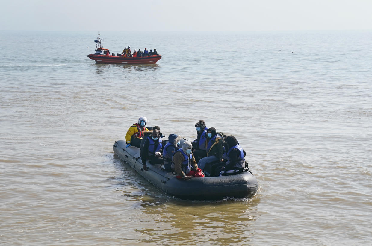 A group of people thought to be migrants are escorted to shore in Kingsdown, Kent, after being intercepted by an RNLI crew following a small boat incident in the Channel. Picture date: Tuesday September 7, 2021.
