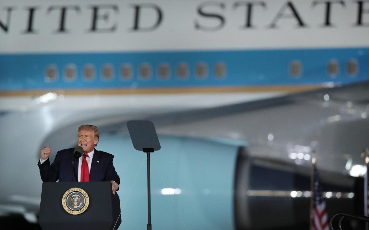 President Donald Trump speaks to supporters at a rally with Air Force One in the background in Freeland, Michigan - Scott Olson/Getty Images