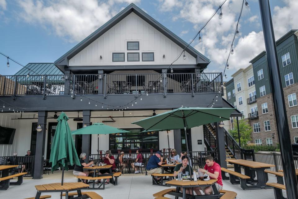 Suann Humphrey, and Brennan Sollenberger, right, live in the adjacent apartment complex and often dine on the large outdoor patio at Old Bag of Nails as they do here at lunchtime Saturday, July 22, 2023.