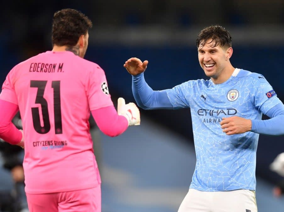 John Stones celebrates with goalkeeper EdersonAFP via Getty Images