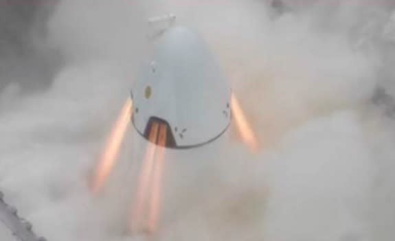 SpaceX's Dragon crew capsule fires its SuperDraco escape engines on May 5, 2015, one day before a crucial pad abort test at Florida's Cape Canaveral Air Force Station.