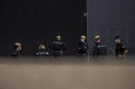 Members of the UME (Emergency Army Unit) gather outside a center used to conduct rapid antigen test for COVID-19 in the southern neighbourhood of Vallecas in Madrid, Spain, Tuesday, Sept. 29, 2020. Madrid has a rate of infection 2.5 times higher than the national average, which is already three times the European average, including the UK. (AP Photo/Bernat Armangue)