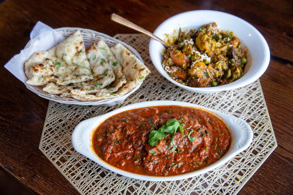 (Left to right) naan flatbread, laal maas (lamb in Rajasthani chili gravy), and Milioni Tarkari (mixed vegetables cooked with tomatoes, herbs, spices and coconut milk) at Mauka Indian Cuisine in Eatontown.